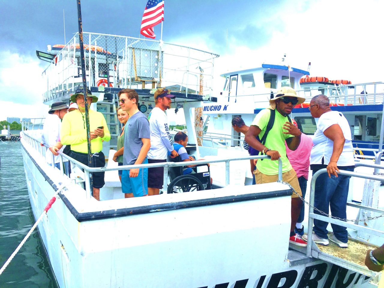 People loading up on the back of a yacht