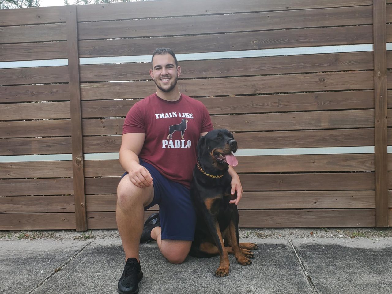 Founder of Train Like Pablo, Ilya Levin posing for the camera with his dog Pablo
