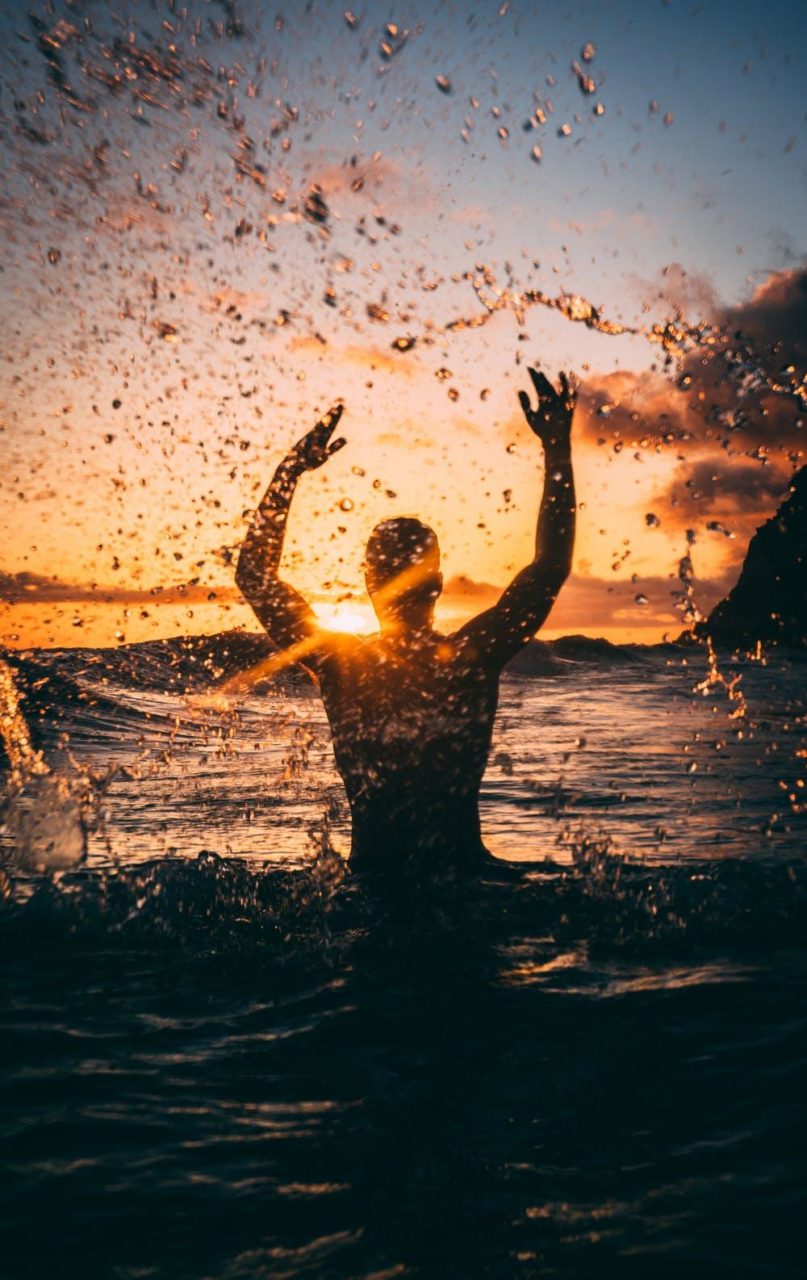 A man splashes in the water at a beach in Miami.
