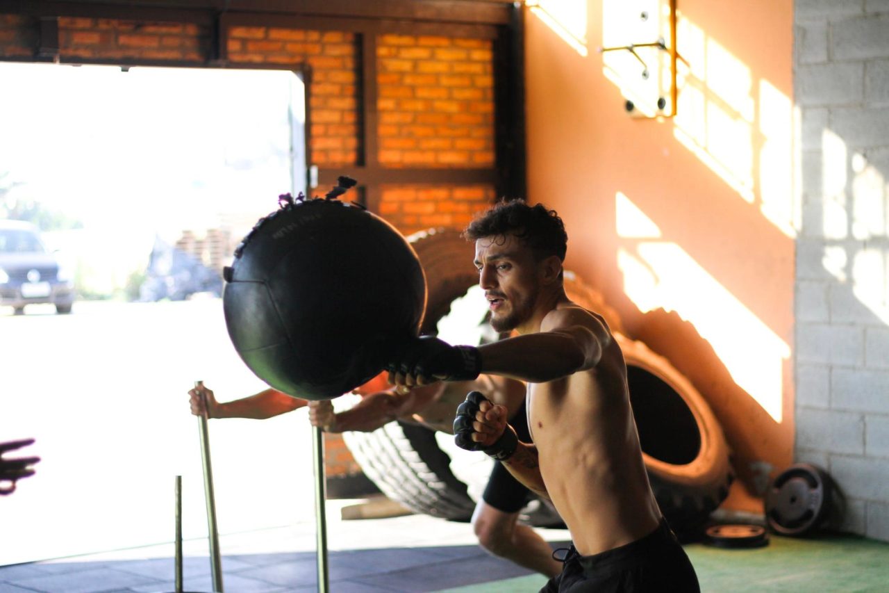 A young man trains intensely practicing for MMA.