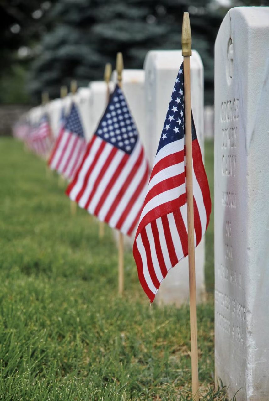 Flags planted on graves to honor the deceased.
