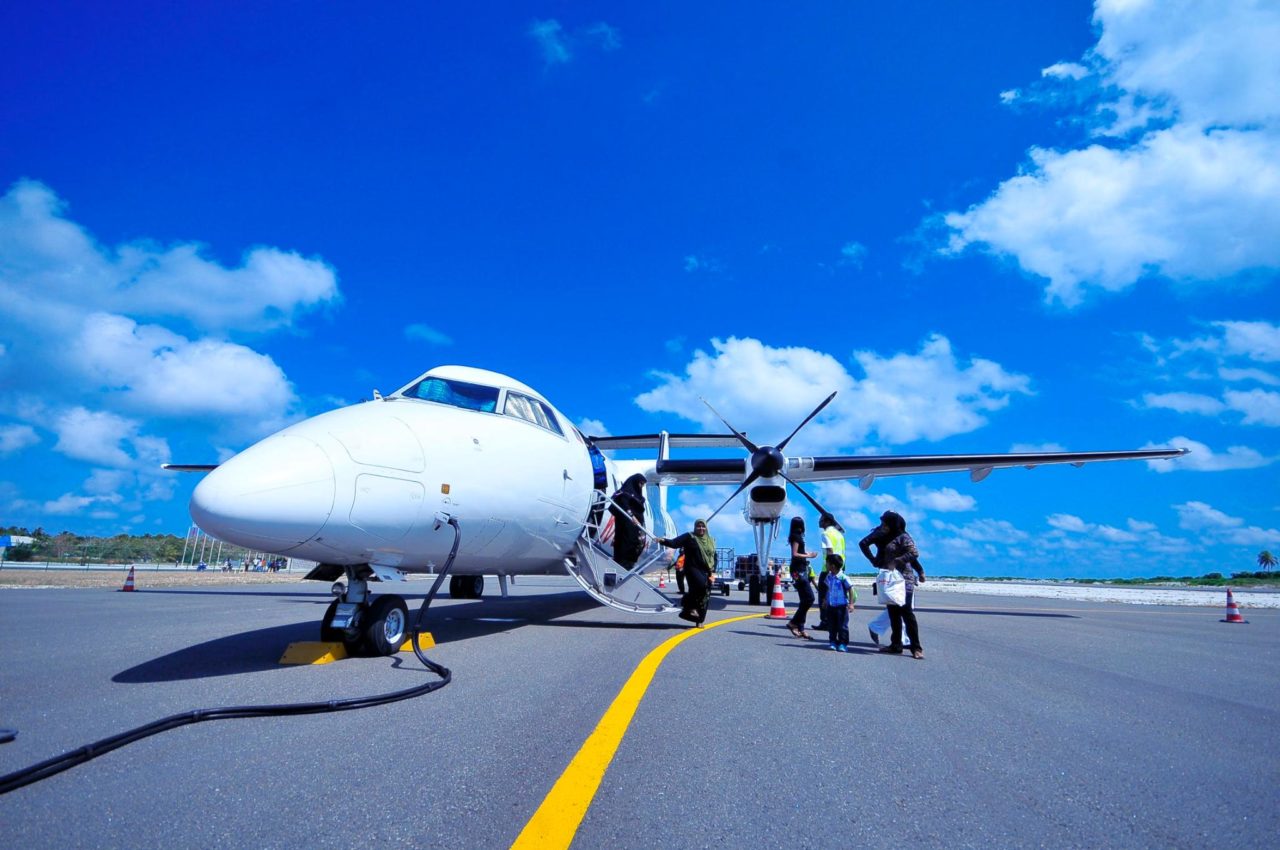 A group of tourists begins to board a private jet.