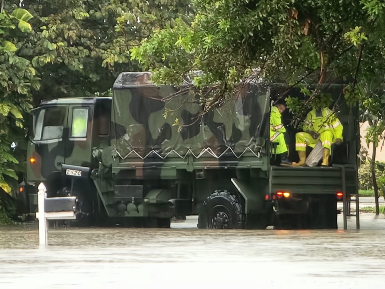 An MDFR rescue truck with rescue workers in a flooded area.