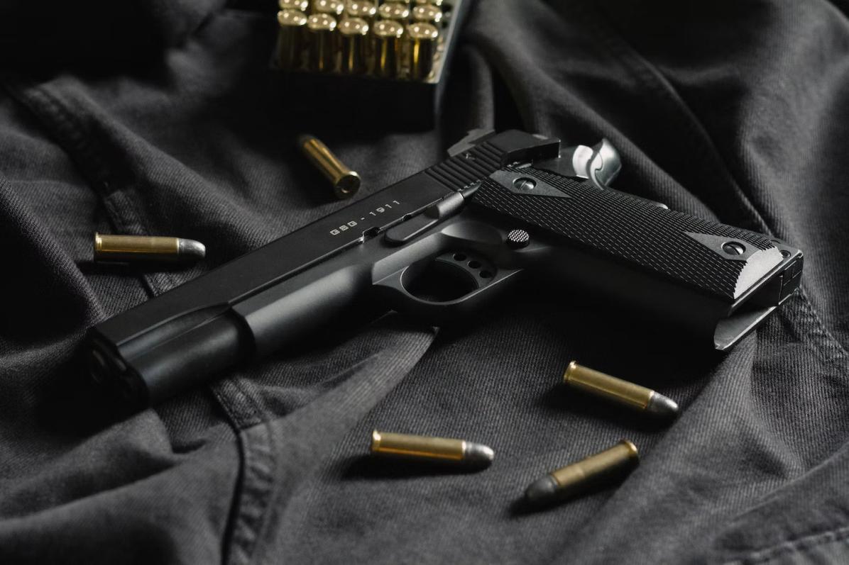 a gun with bullets lying around