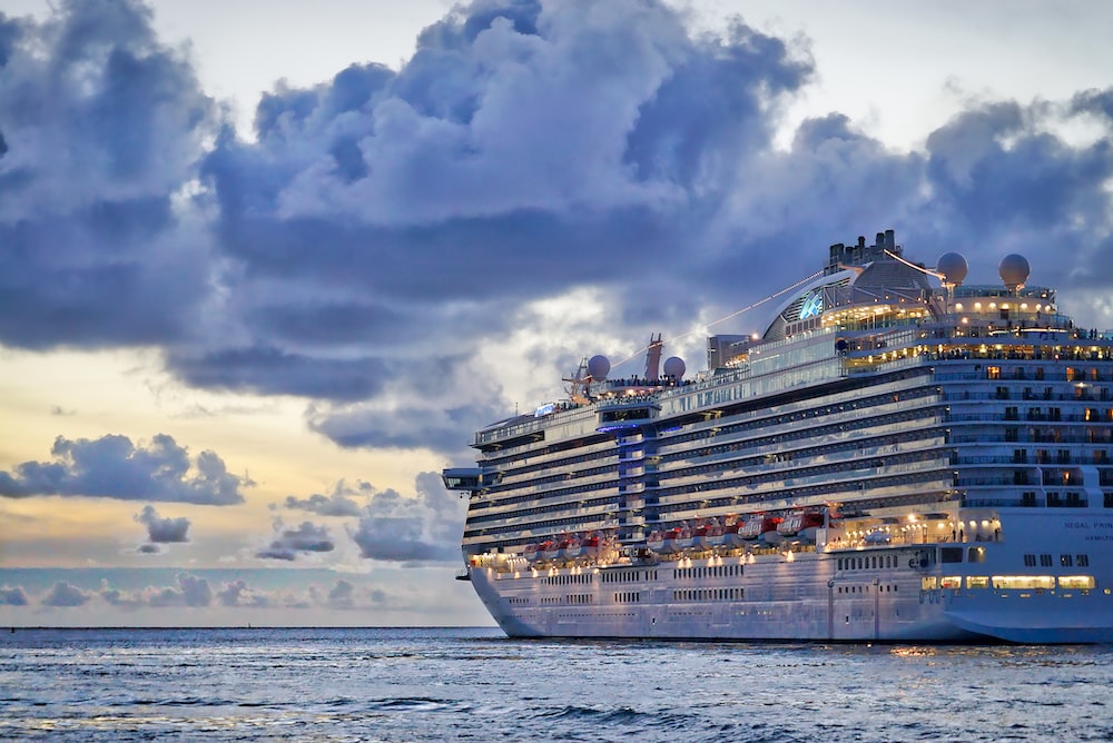 un gran crucero con luces navegando en el mar