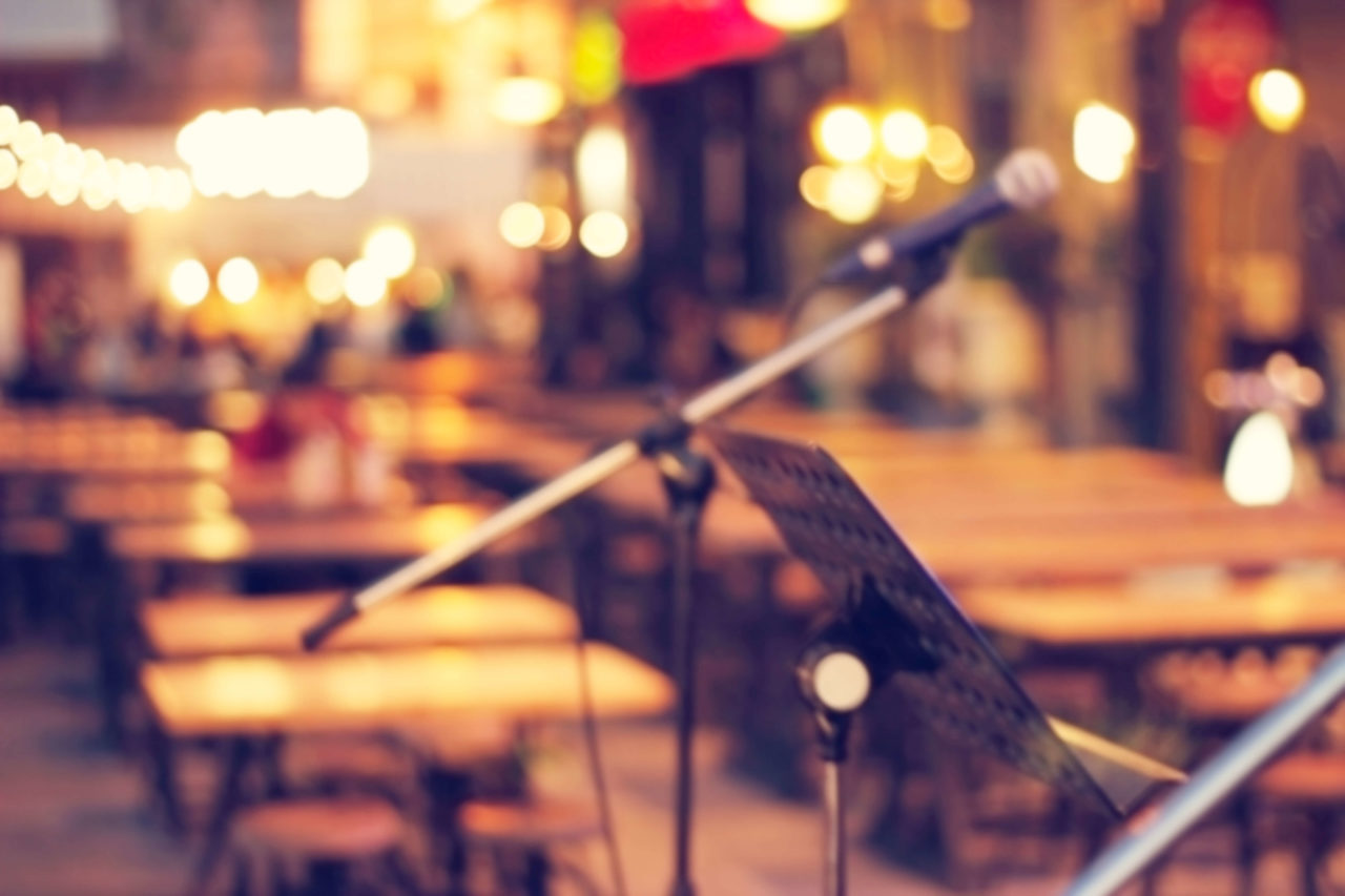 CLOSE UP OF MICROPHONE AND RESTAURANT BACKGROUND