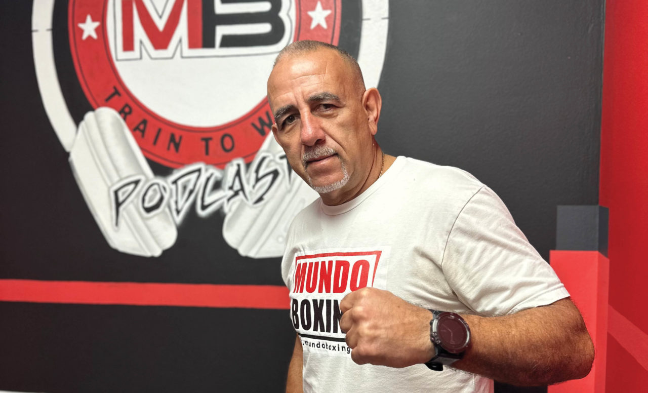 Pedro Diaz Infront of the Mundo Boxing logo