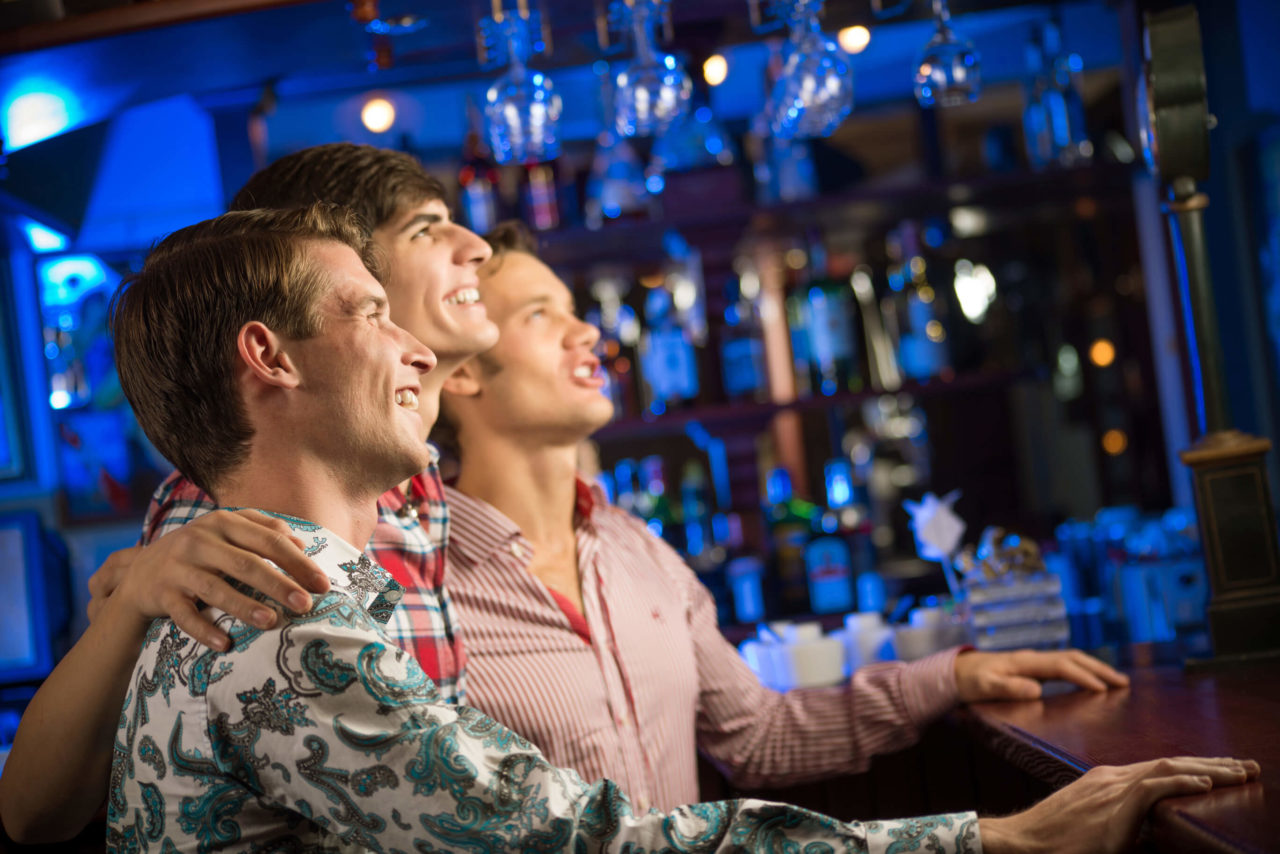 Three guys enjoying at bar
