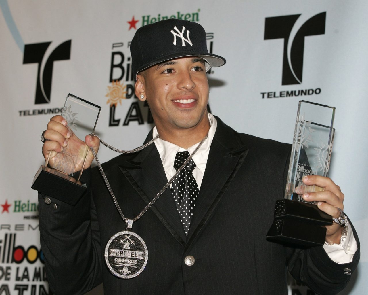 Daddy Yankee holding awards