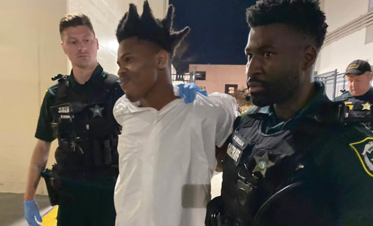 Keith Melvin Moses handcuffed with officers