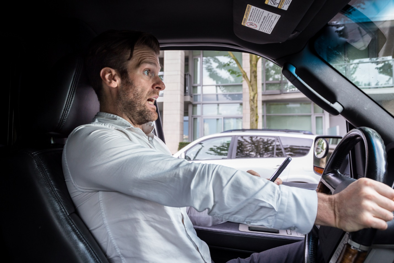 A person alarmed and texting while driving