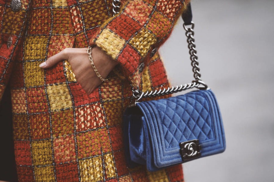 Woman carrying blue velvet Branded Handbag
