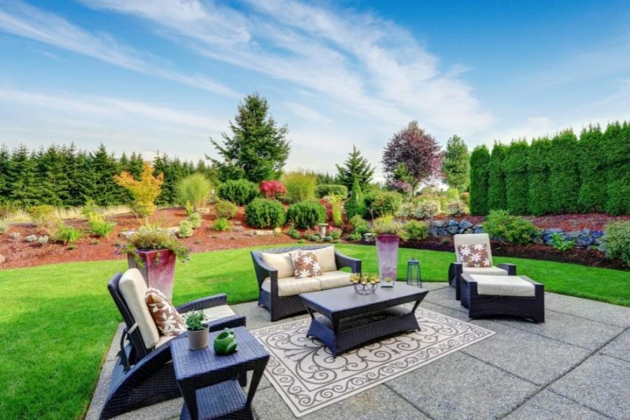 A lush backyard with comfy seating
