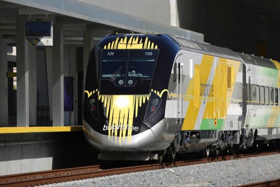 A Brightline train arriving at a station