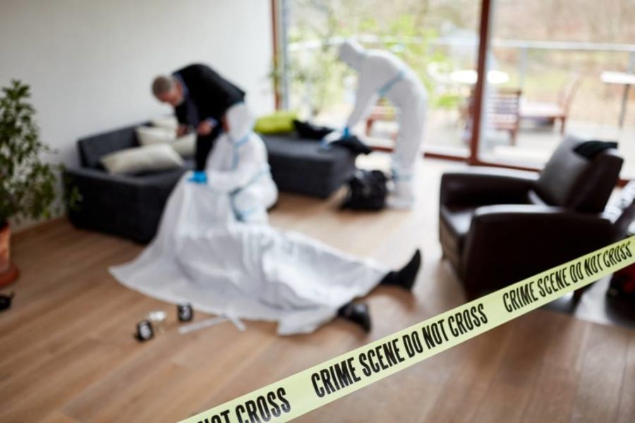 Yellow tape and officials at a crime scene