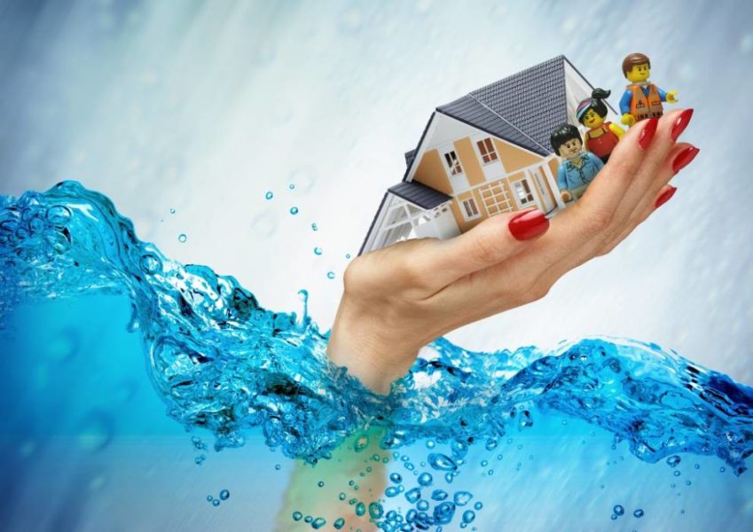 an illustration of a drowning hand holding a miniature house model