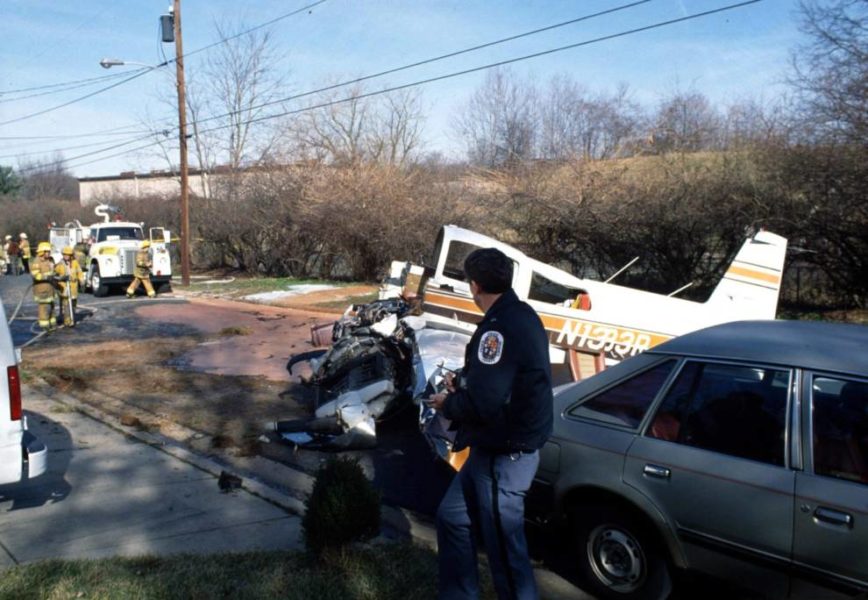plan crash on road with fire fighters on the scene