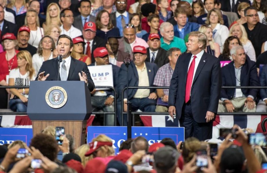 DeSantis and Trump standing on a stage