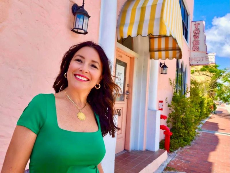 Denise Galvez Turros posing for picture in front of hotel