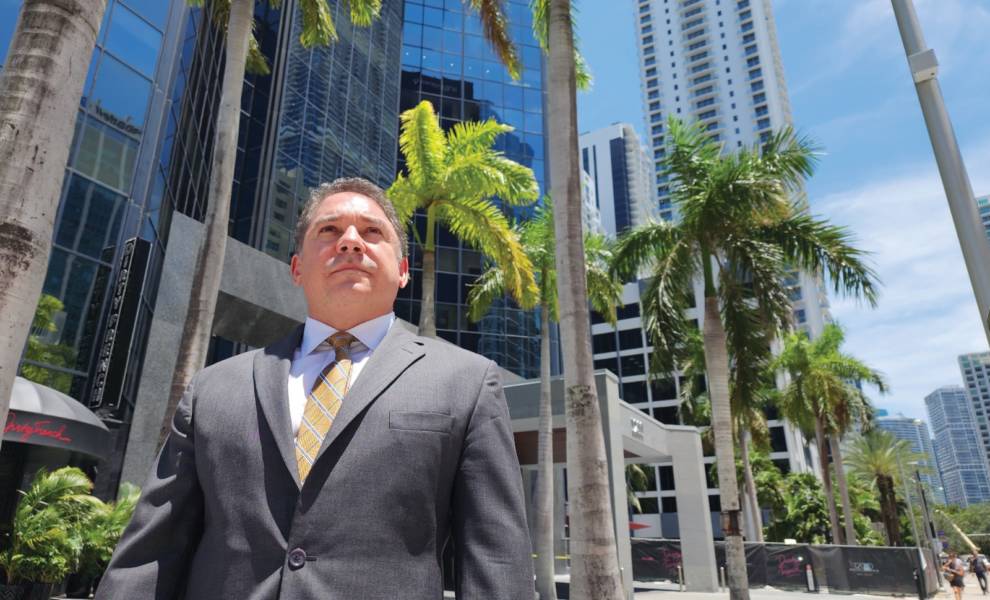 Ronald Sanchez posing for picture in front of building