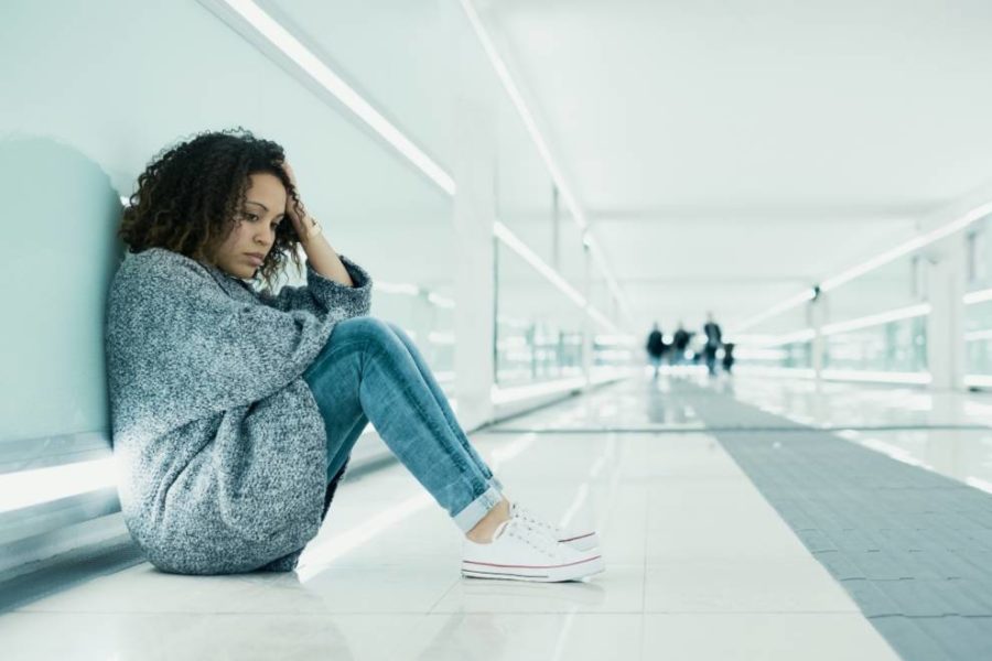 A person sitting on the floor alone