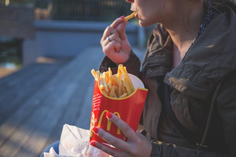 A woman eating McDonald’s French fries