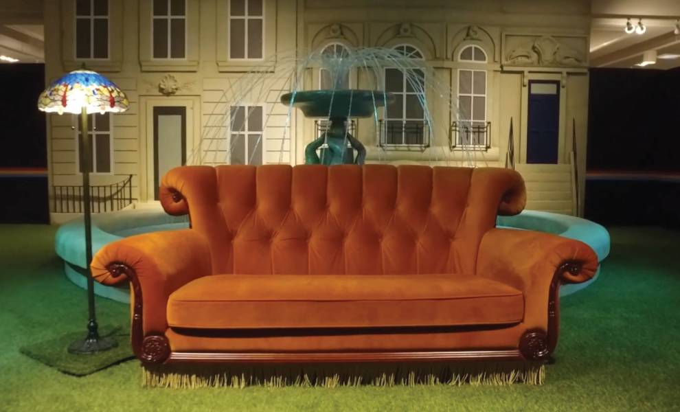 Orange couch in front of a fountain