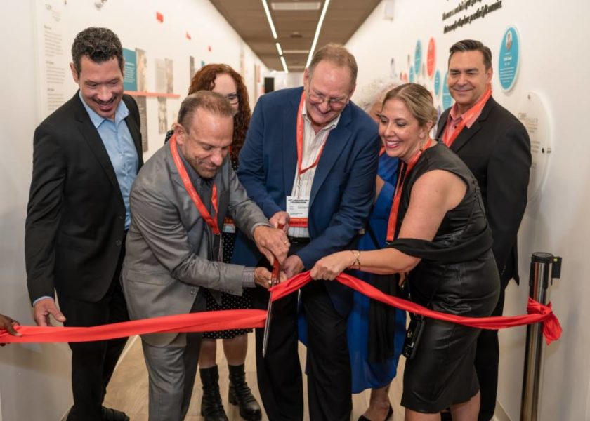 Rick Siclari, CEO celebrating 40 years of service Care Resource by cutting the ribbon with other people.