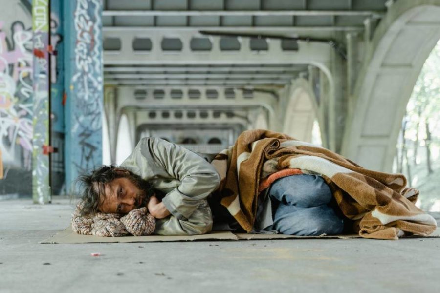 A homeless person lying on the floor