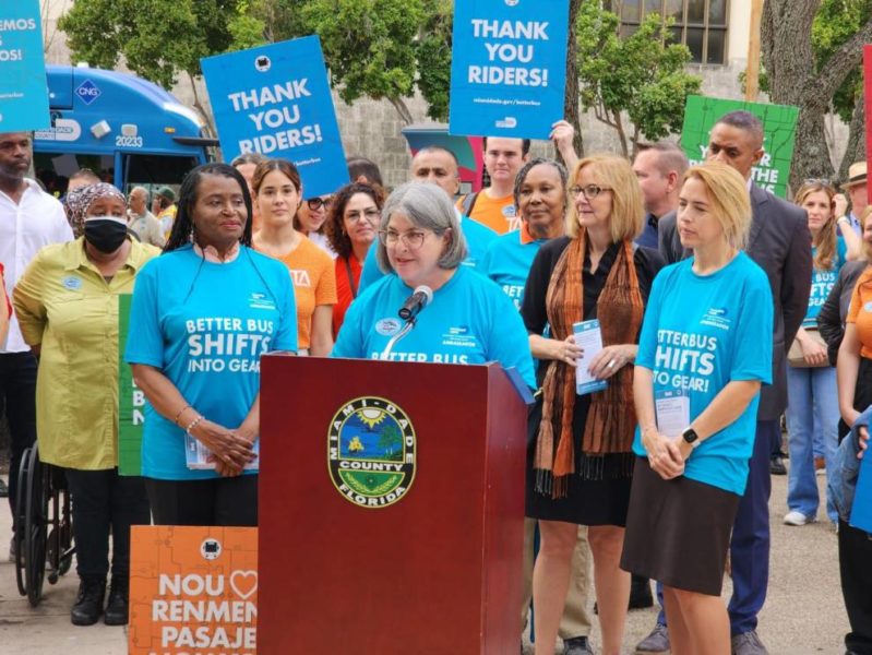 A diverse group of individuals standing before a podium, engaged in a public gathering