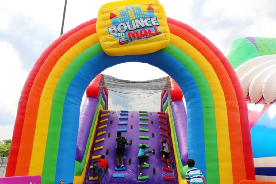 Bounce The City A vibrant bouncy castle filled with joyous children, bouncing and playing together