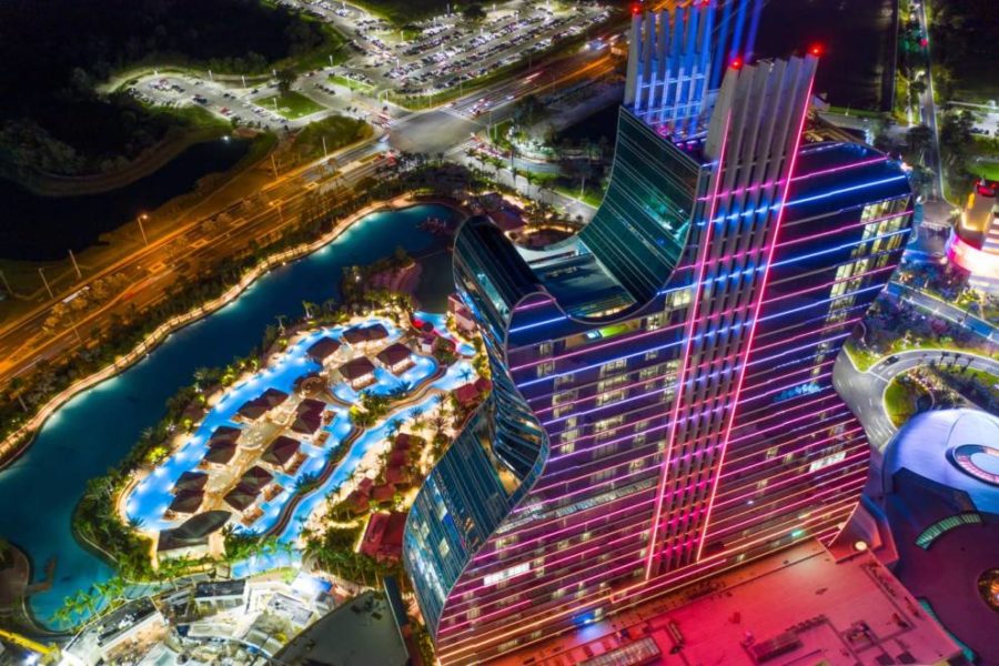 An illuminated cityscape seen from above during nighttime, showcasing the urban landscape and its twinkling lights