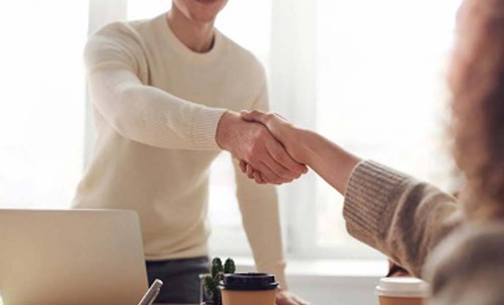 Man and woman engaged in a negotiation near a table
