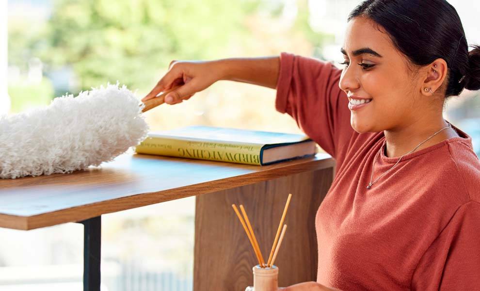 A woman holding a fluffy white pillow, providing comfort and support for a peaceful night's sleep