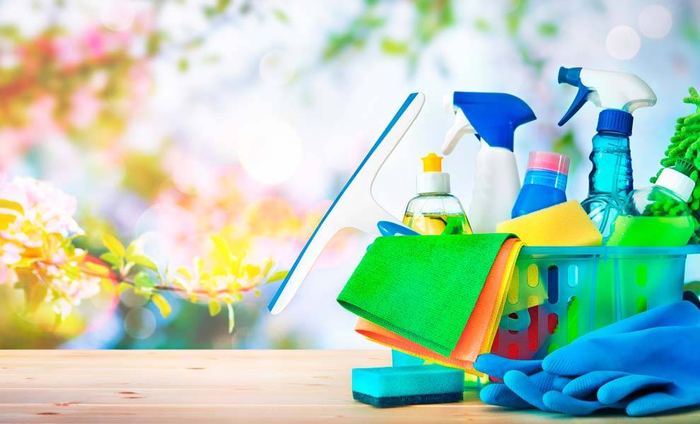 Spring cleaning equipment spread out on a wooden surface