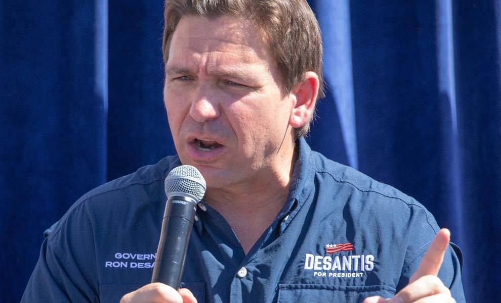 Governor Ron DeSantis holding a microphone