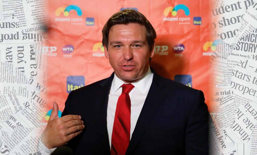 Hombre de negocios con traje y corbata parado frente al periódico.