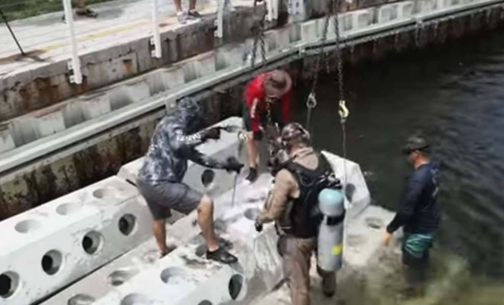 Varias personas trabajando en un barco en el agua, realizando diversas tareas y colaborando eficientemente.