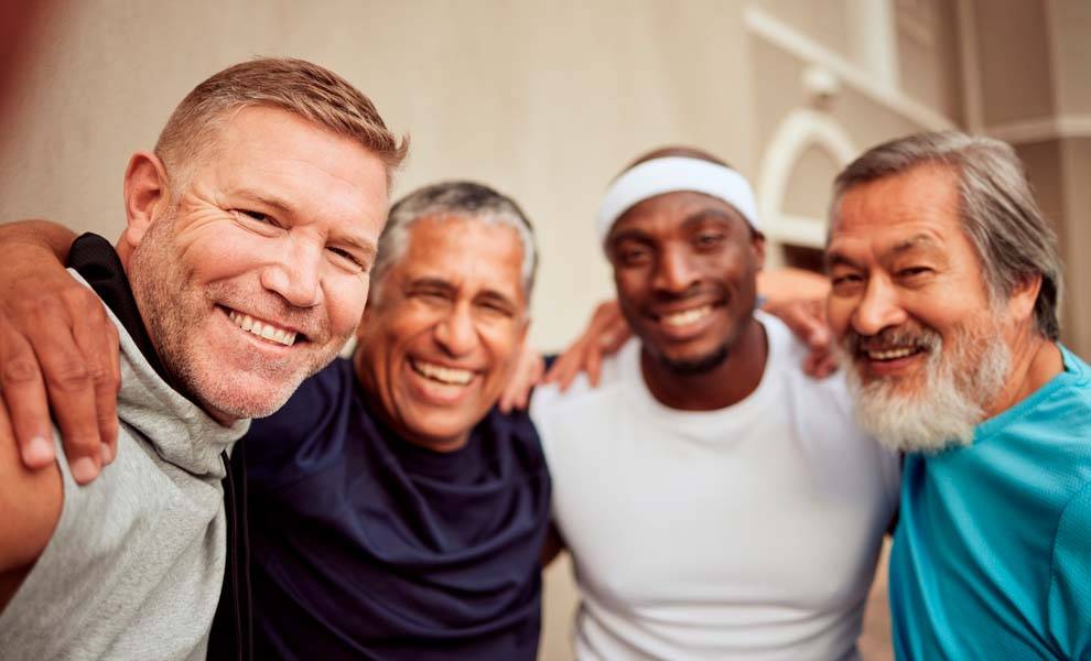 Four men smiling and posing for a photo.