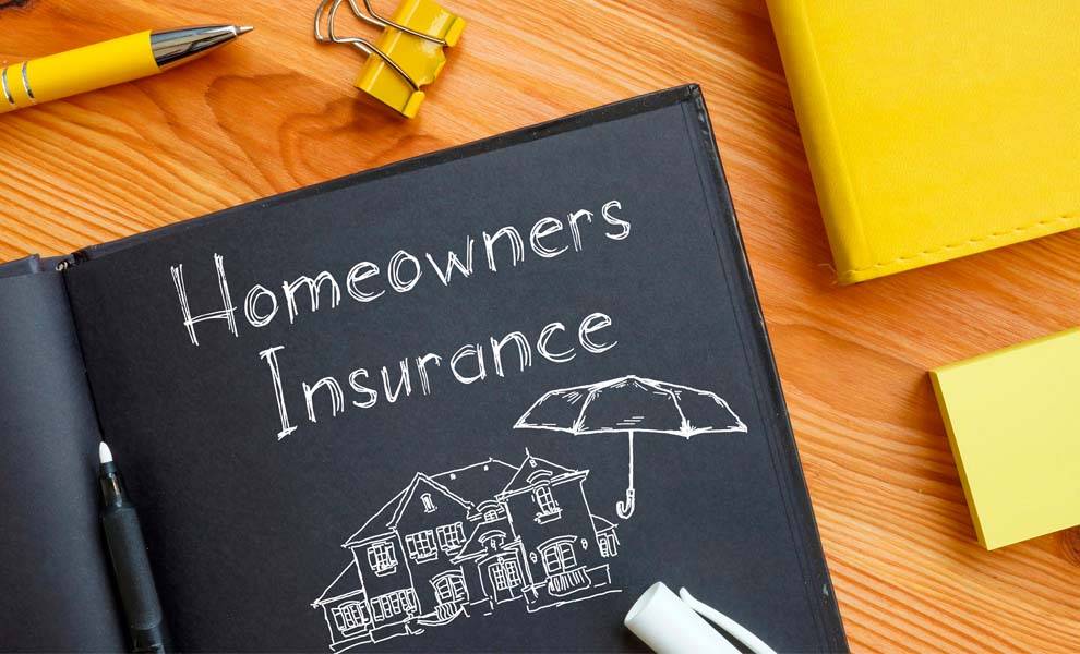 Homeowners' insurance policy book on desk.