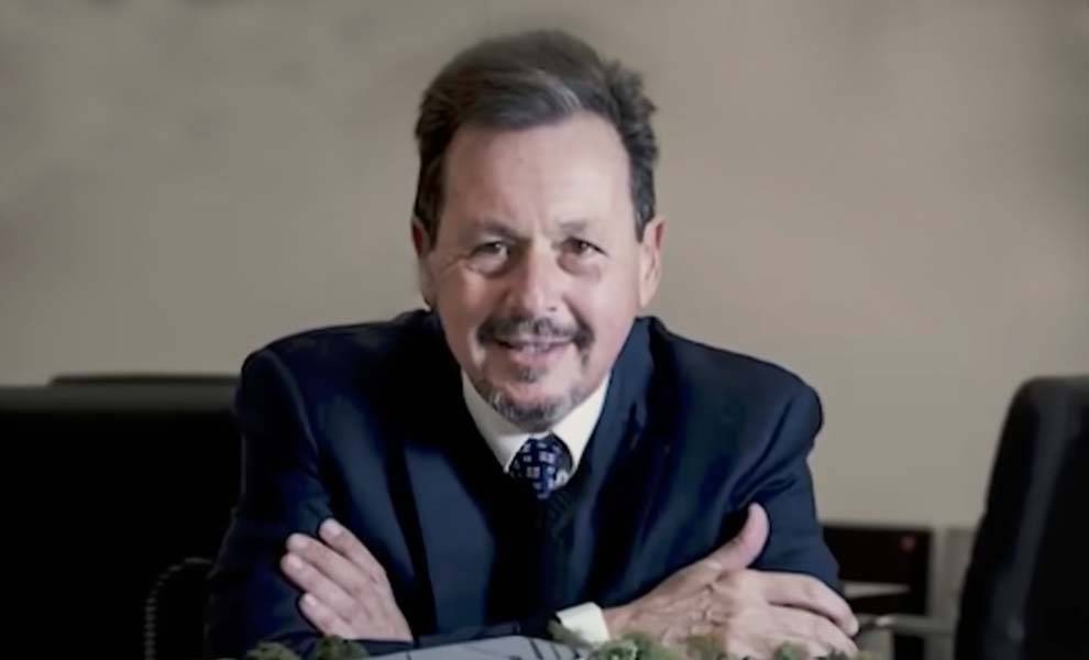 A businessman in a suit sitting at a desk.