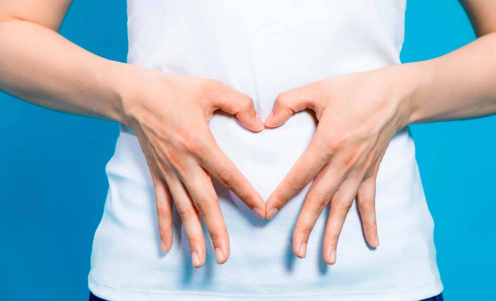 A woman forming a heart shape with her hands.