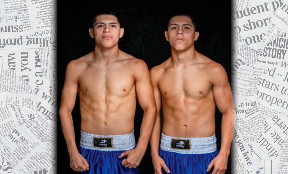 Two young men in blue shorts, standing together.
