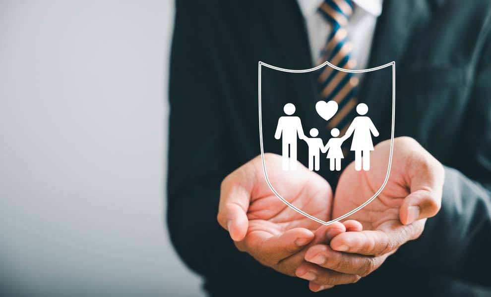 A man in suit holding a family shield.