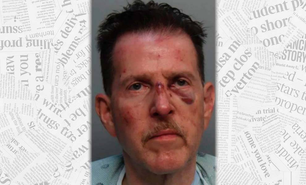 A mug shot of a man with a mustache, displaying a bruised face.