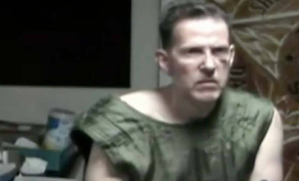 Un hombre vestido con una camisa verde en el juzgado.