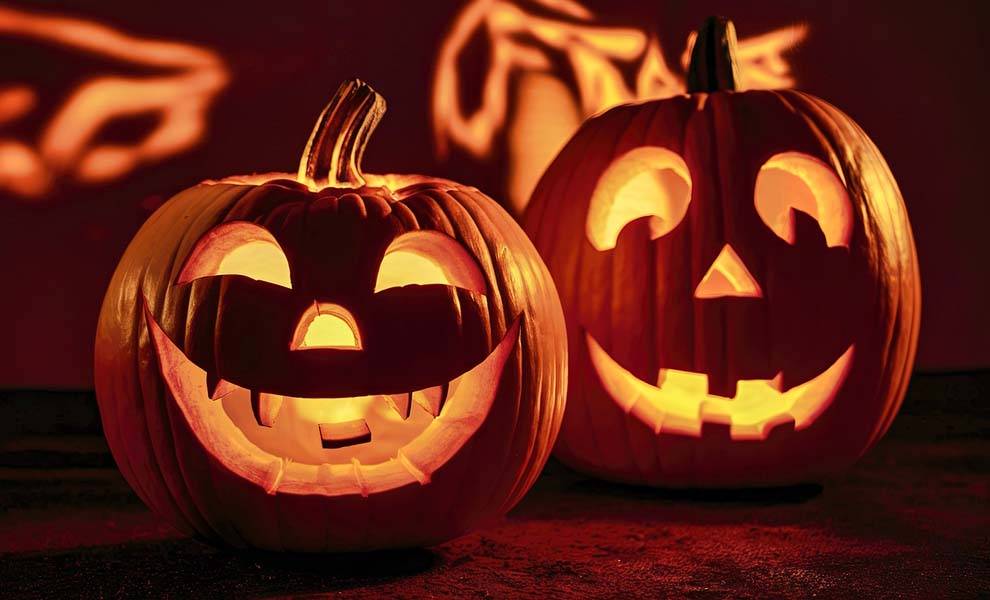 Two carved pumpkins with distinct facial expressions.