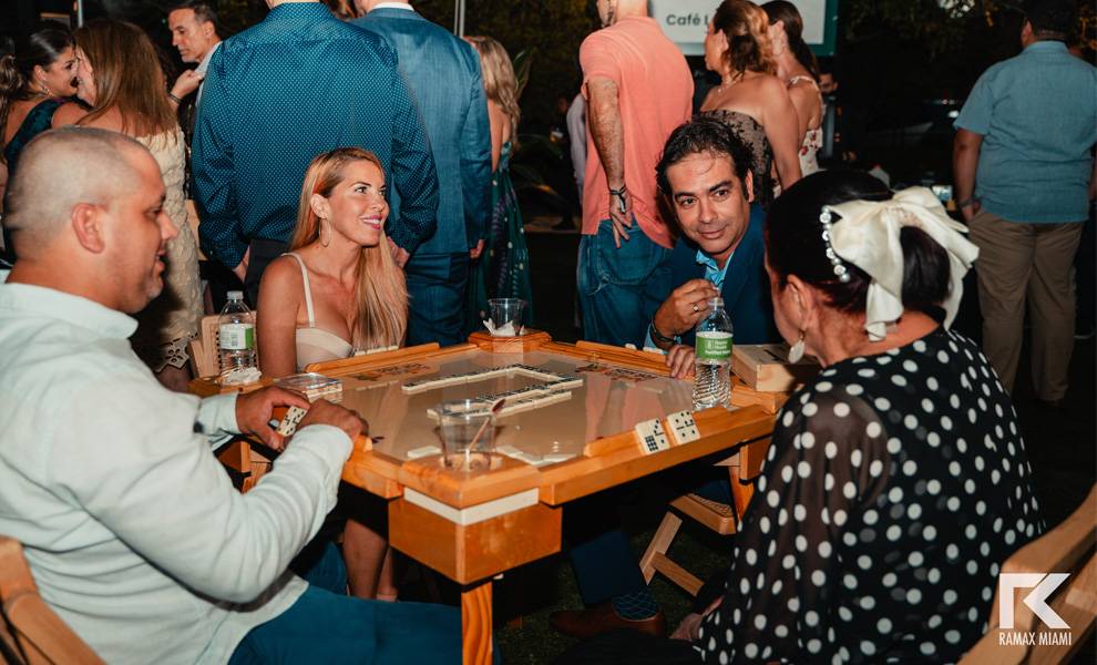 A group of individuals playing dominos at Amigos Night 2024.