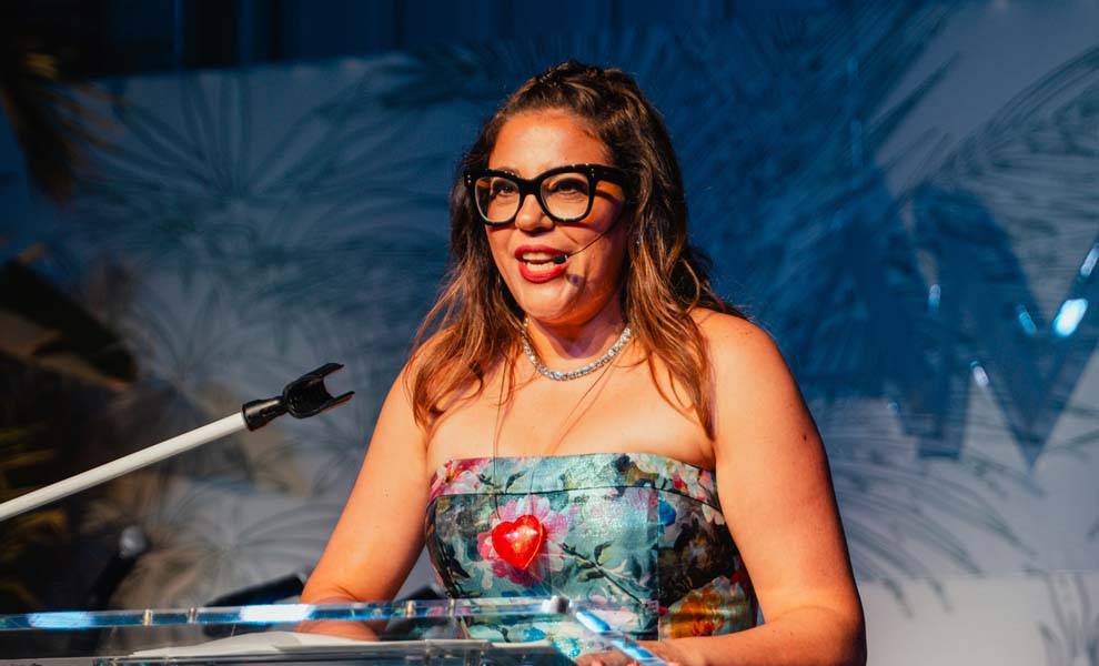 CEO Karina Pavone of Amigos For Kids speaking at the Amigos Night event.