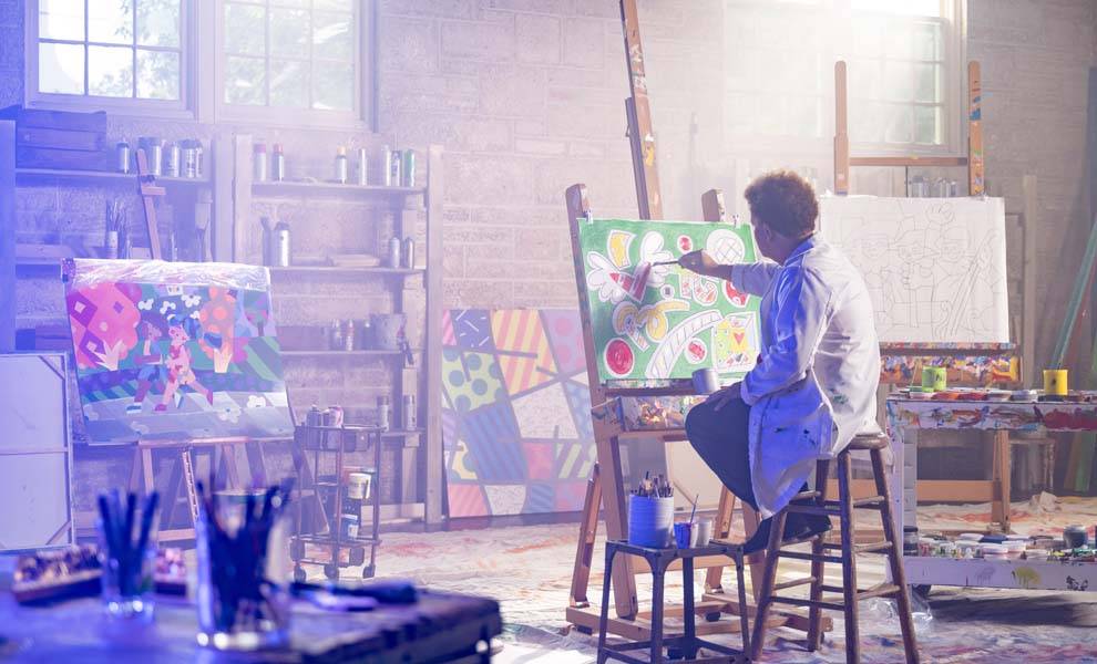 El artista Romero Britto en su estudio creando arte.